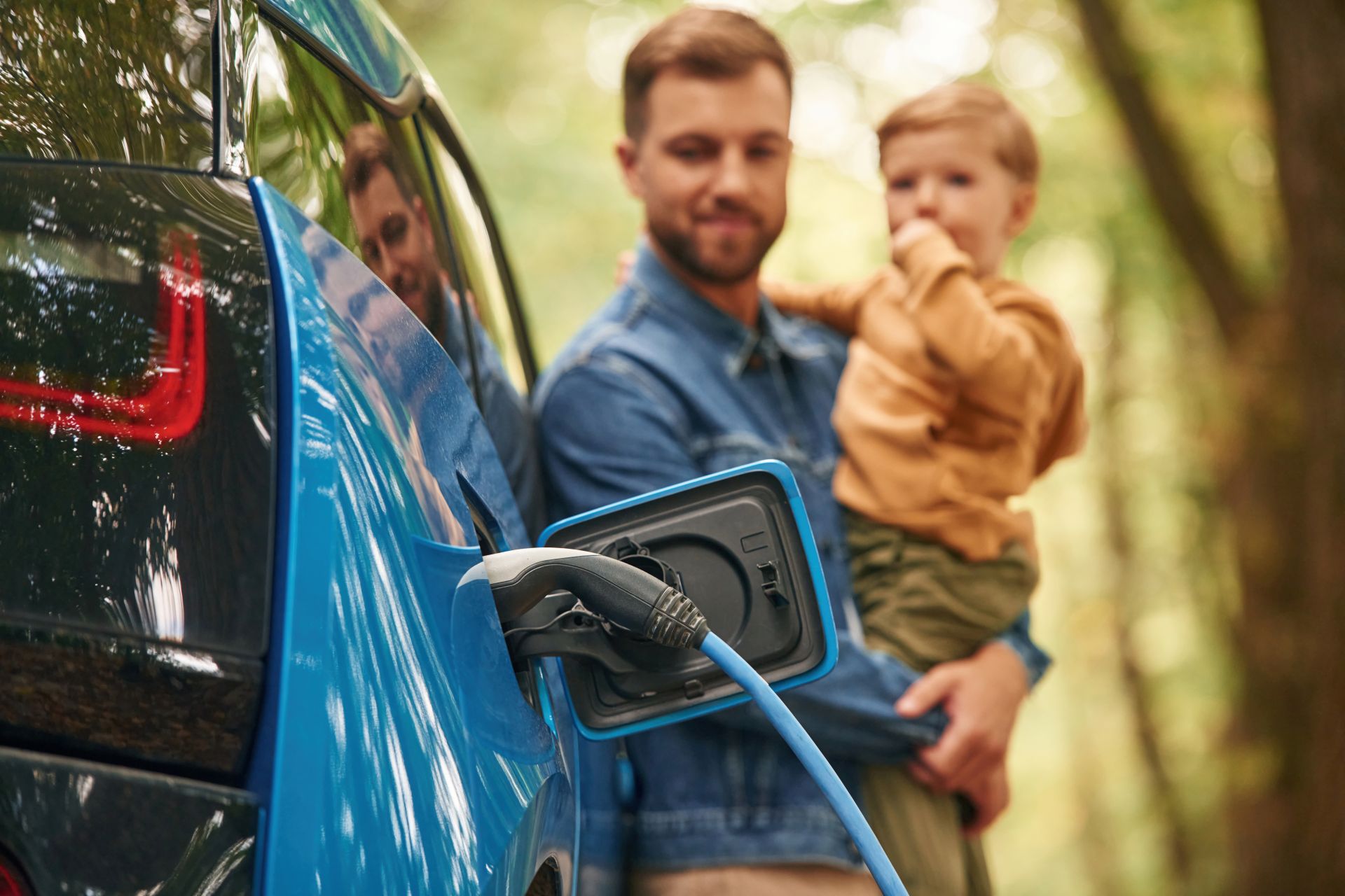 Father with child charging car